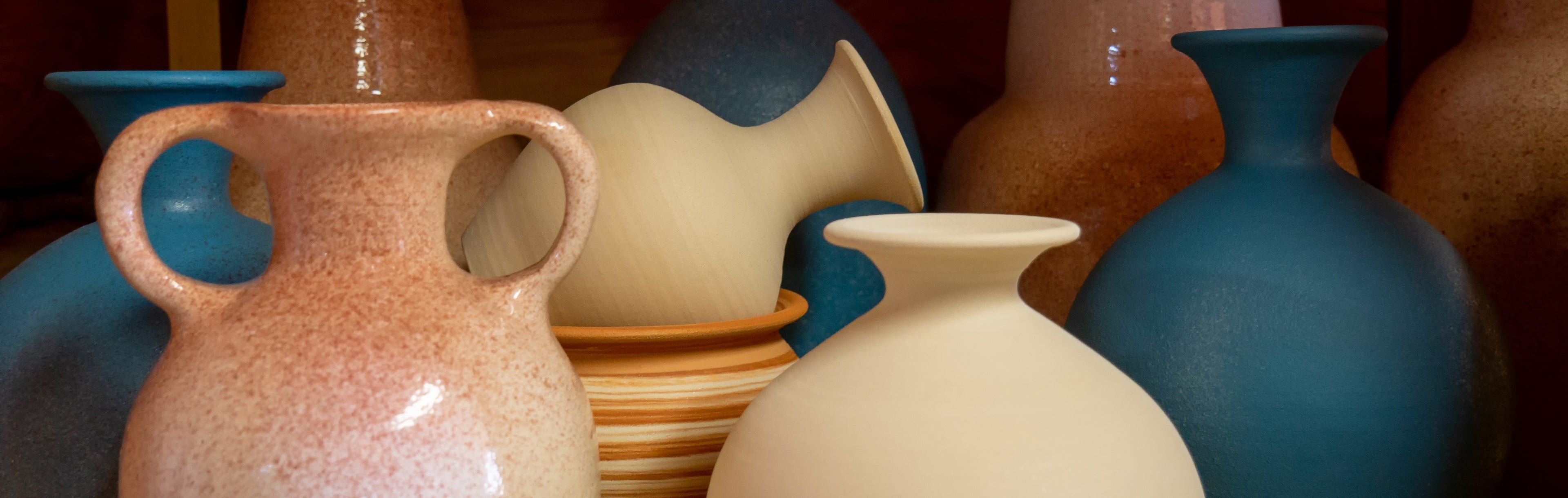 Membership - The Pottery Hut Mississauga - different colour big pottery pots piled up on display