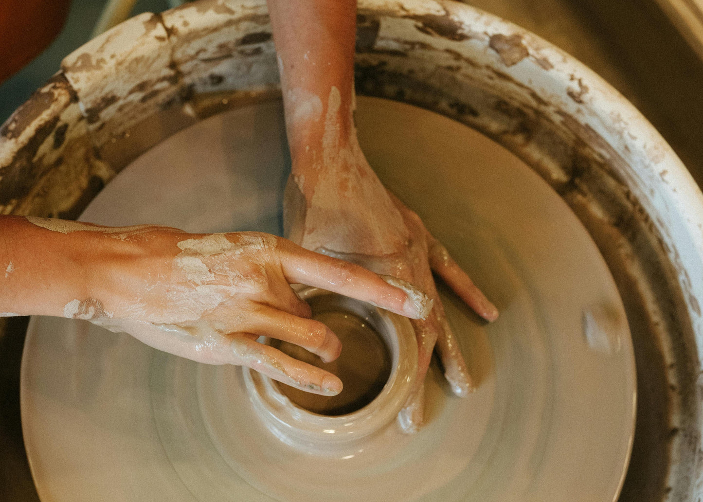 Gift A Pottery Class - The Pottery Hut Mississauga - hands molding pottery piece on pottery wheel