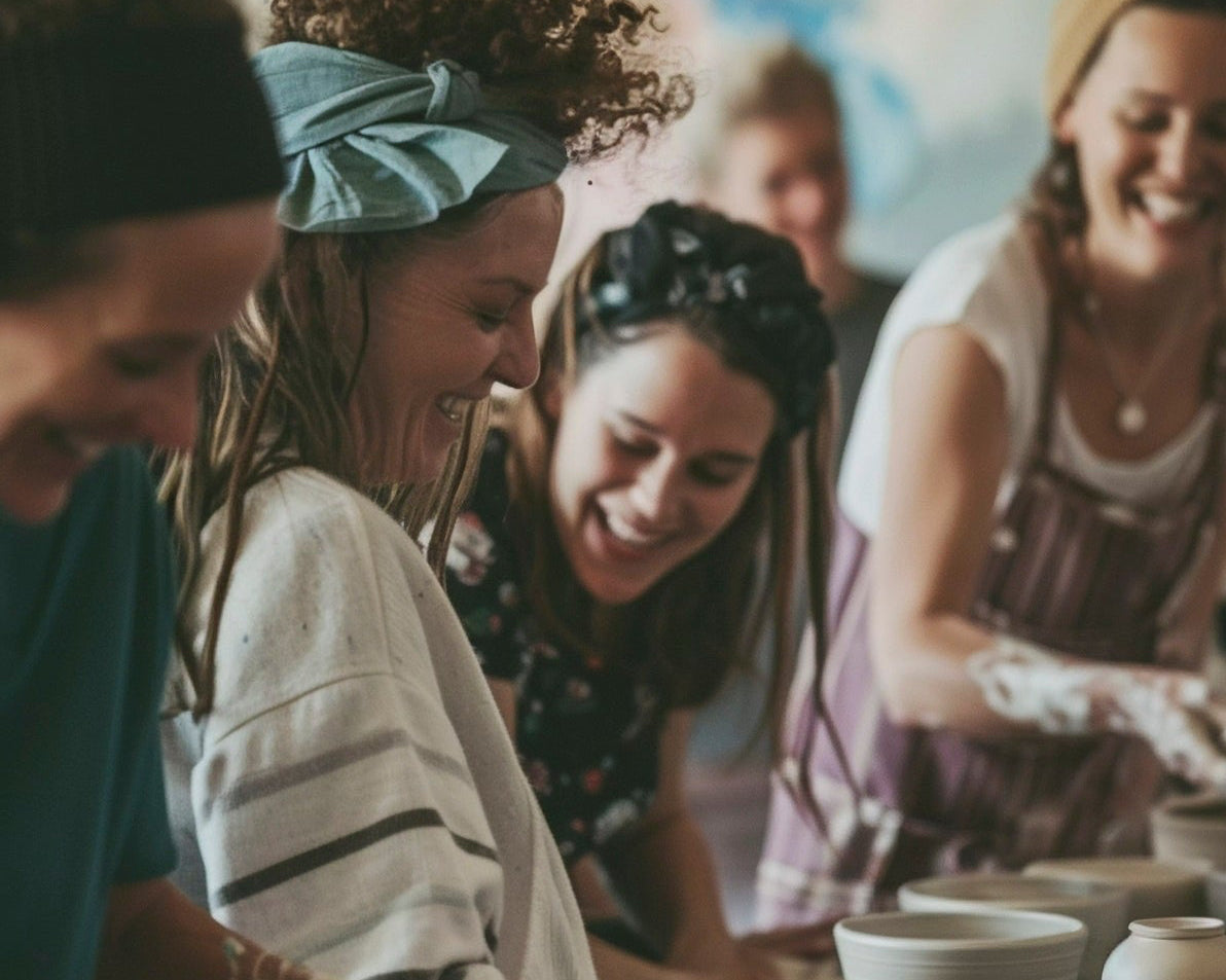 Private Pottery Class - The Pottery Hut Mississauga - Group of women working on pottery pieces together laughing having fun